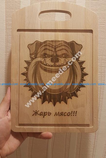 the cutting board engraved the face of a sloppy dog